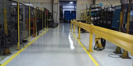 Industrial grade flooring—high-durability coated floor with safety yellow markings in a heavy equipment area.