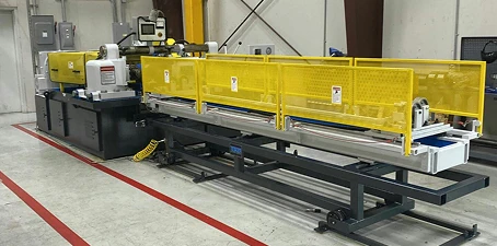 Industrial machinery in a workshop painted with a clean finish and safety yellow guards installed around moving parts.