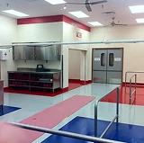 Food processing facility with brightly colored red and blue thermal shock resistant flooring, designed for durability under extreme temperature changes.